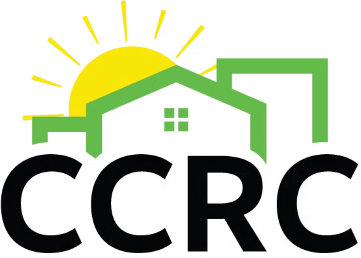 CCRC logo in bold black text with a green outline of homes above it and a yellow sun peeping out