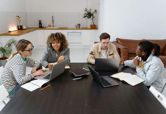 REACH banner image showing a group of coworkers having a discussion