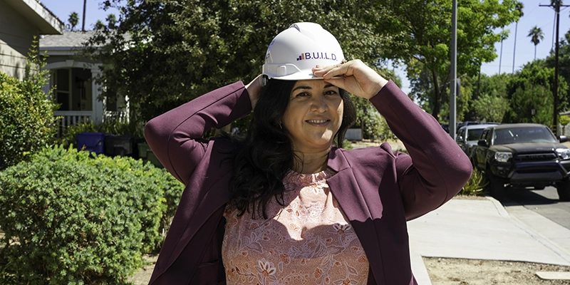 Alicia Matricardi of Matricardi Law putting on a BUILD hard hat