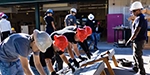Group of construction apprentices leveling a rail with lead instructor observing thumbnail