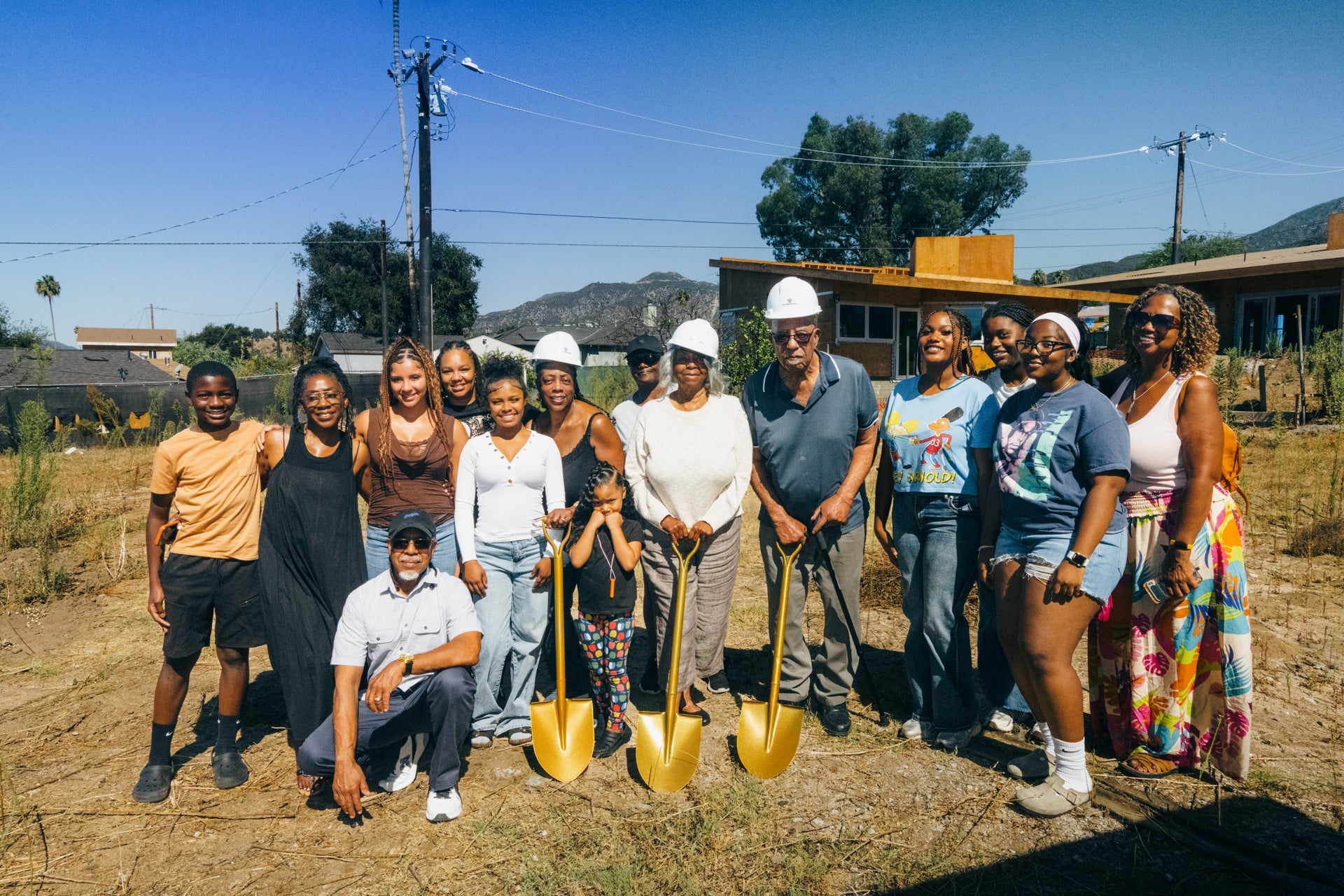 Brenda Sanchez of B.A.S. Construction a member of The Center’s Contractors Accelerator for Climate Resilience Disaster Recovery Cohort with a family they helped rebuild in Altadena after the CA wildfires.